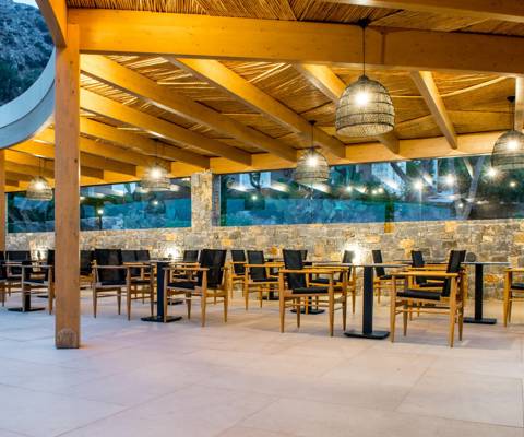 Marni Village outdoor restaurant seating area under wooden pergola with ambient lighting