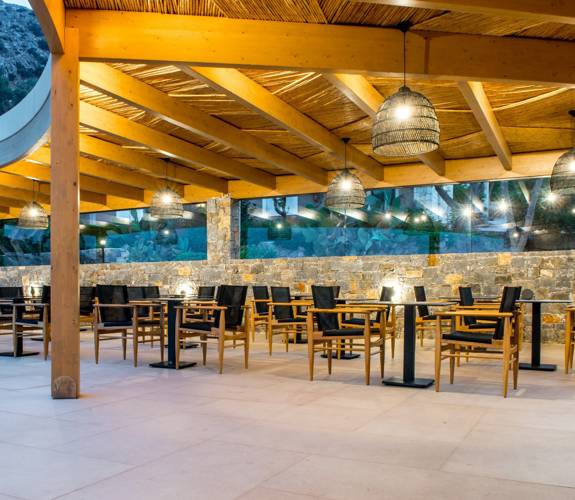 Marni Village outdoor restaurant seating area under wooden pergola with ambient lighting