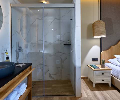 Marni Hotel Deluxe Bungalow Private Pool bathroom with marble walk in shower and wooden vanity