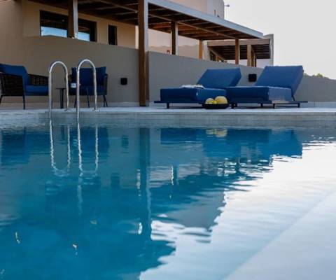 Marni Hotel Luxury One Bedroom Villa outdoor pool area with wooden pergola, sitting area and sunbeds