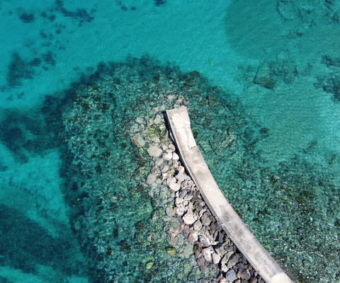 Aerial view of Hersonissos fishing port with the clean and calm waters