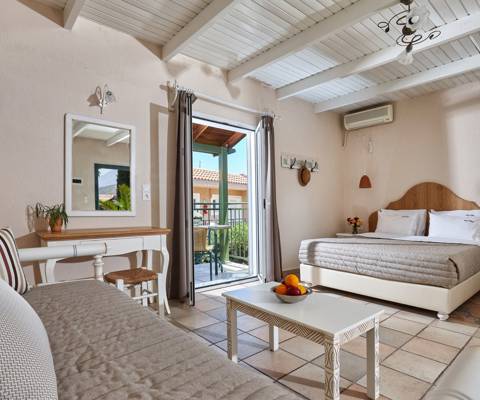 Marni Hotel Superior Studio interior with double bed, sofa bed, and balcony access