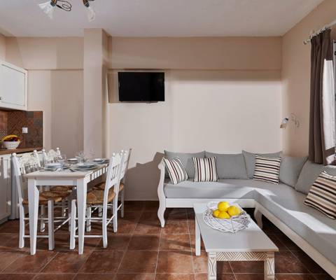 Marni Hotel Premium One Bedroom Apartment living room with dining area and wall-mounted TV