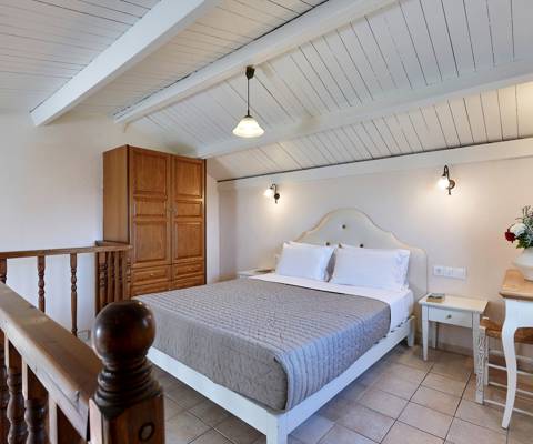 Marni Hotel Maisonette upper floor with double bed, wooden wardrobe and sloped ceiling