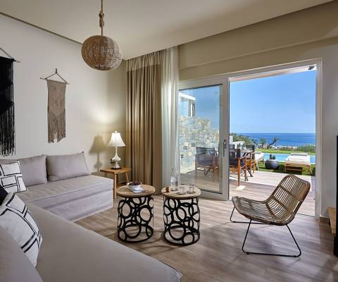 Marni Hotel Deluxe Maisonette Private Pool living area with boho decor, sofas, modern staircase and sea view terrace