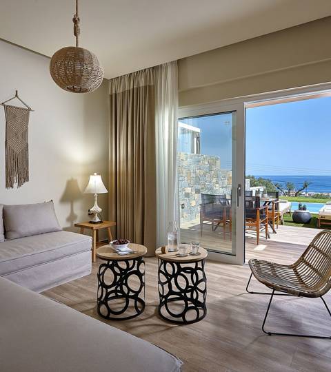 Marni Hotel Deluxe Maisonette Private Pool living area with boho decor, sofas, modern staircase and sea view terrace