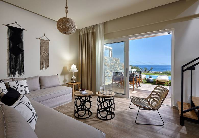 Marni Hotel Deluxe Maisonette Private Pool living area with boho decor, sofas, modern staircase and sea view terrace