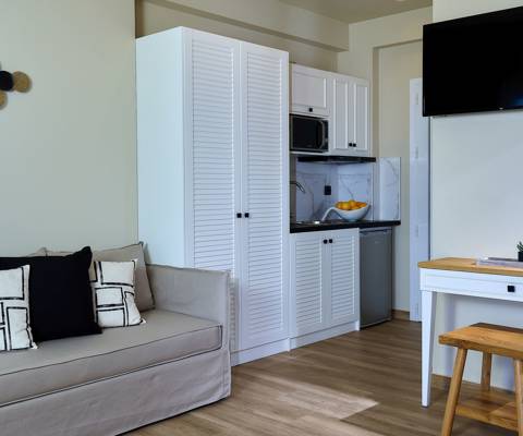 Marni Hotel Deluxe Bungalow Private Pool kitchenette with white cabinets, microwave and compact fridge