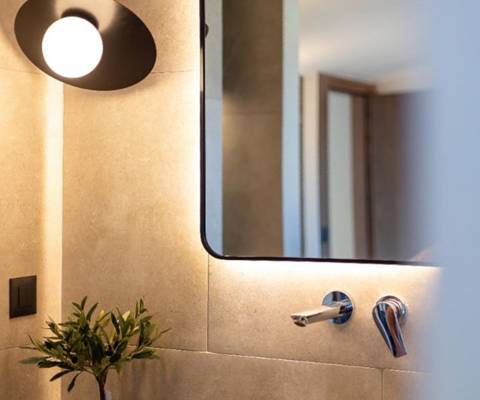 Marni Hotel Luxury two Bedroom Villa backlit mirror, vessel sink, bathroom amenities and modern lighting
