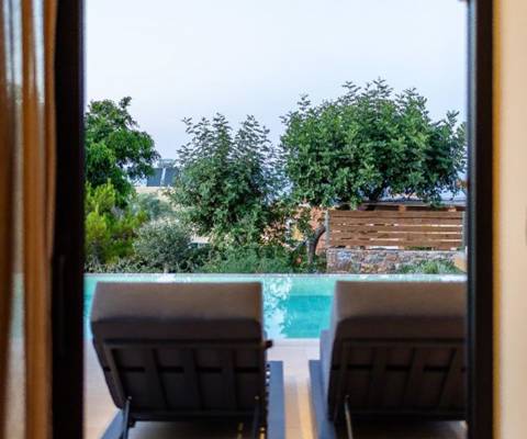 Marni Hotel Luxury Two Bedroom Villa window view of the private pool area with sunbeds