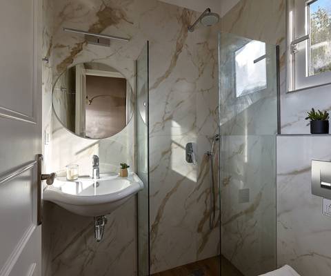 Marni Hotel Superior Family Suite Private Pool bathroom with round mirror, and walk in shower