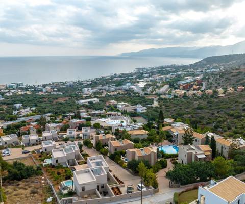 Marni Village aerial view of Hersonissos coastline and hillside villas with the view of the sea