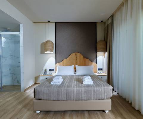 Marni Hotel Deluxe Bungalow Private Pool bedroom with double bed, pendant lights and modern glass-walled shower