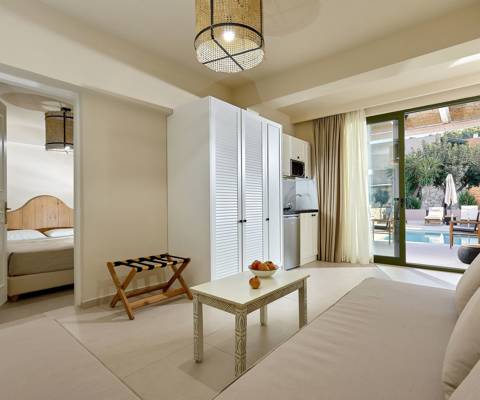 Marni Hotel One Bedroom Apartment Private Pool living area with sofa, kitchenette and pool access