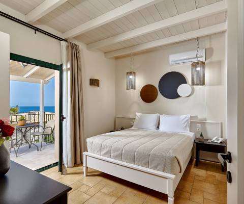Marni Hotel Superior Suite bedroom with modern design and private balcony with sea view 