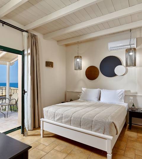 Marni Hotel Superior Suite bedroom with modern design and private balcony with sea view 