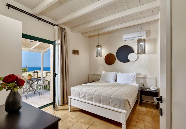 Marni Hotel Superior Suite bedroom with modern design and private balcony with sea view 