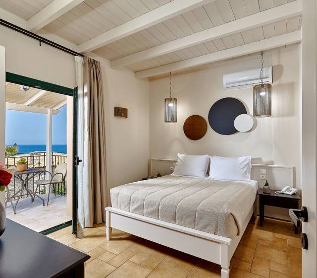 Marni Hotel Superior Suite bedroom with modern design and private balcony with sea view 