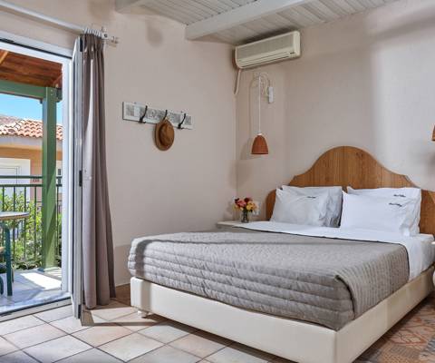 Marni Hotel Premium Studio bedroom with balcony access and natural light