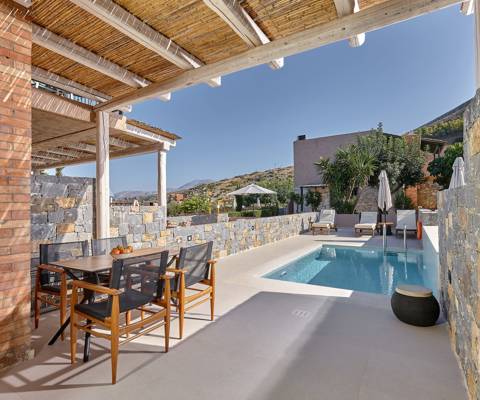 Marni Hotel One Bedroom Apartment outdoor area with sitting area, bamboo pergola and private pool with sunbeds