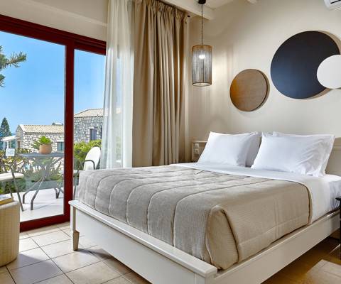 Marni Hotel Superior House Suite bedroom with double bed, bedside tables and access to private terrace