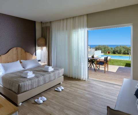 Marni Hotel Deluxe Bungalow Private Pool bedroom with double bed, sofa, sea view and access to the pool area