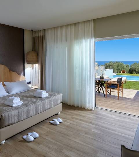 Marni Hotel Deluxe Bungalow Private Pool bedroom with double bed, sofa, sea view and access to the pool area