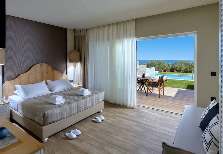 Marni Hotel Deluxe Bungalow Private Pool bedroom with double bed, sofa, sea view and access to the pool area