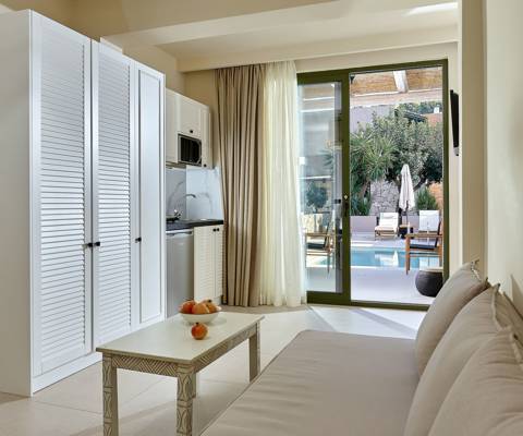 Marni Hotel One Bedroom Apartment Private Pool living area with sofa, kitchenette and pool access