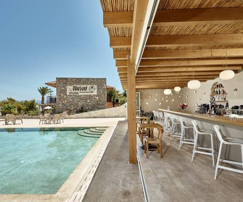Marni Village outdoor pool bar with sunbeds and umbrellas
