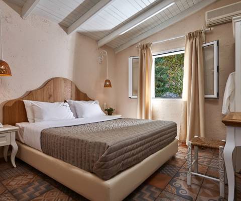Marni Hotel Premium One Bedroom Apartment bedroom with double bed, rustic decor and window view