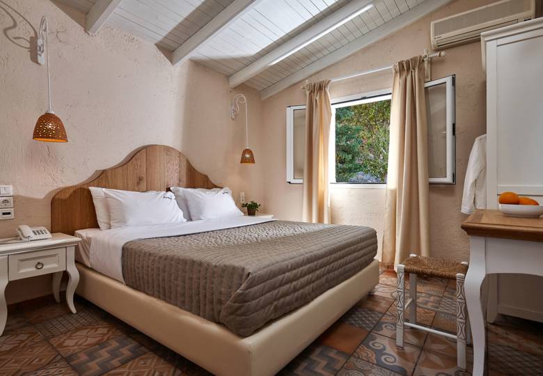 Marni Hotel Premium One Bedroom Apartment bedroom with double bed, rustic decor and window view