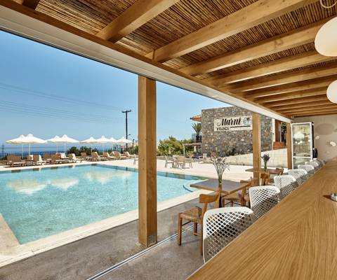 Marni village bar under wooden pergola near the pool with umbrellas and sunbeds