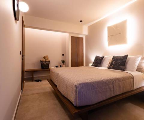 Marni Hotel Luxury Two Bedroom Villa bedroom with double bed and warm modern lighting