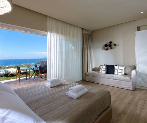 Marni Hotel Deluxe Bungalow Private Pool bedroom with sea view, double bed, sofa and access to outdoor pool area