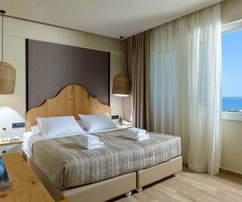 Marni Hotel Deluxe Maisonette Private Pool bedroom with double bed, pendant lights and sea window view