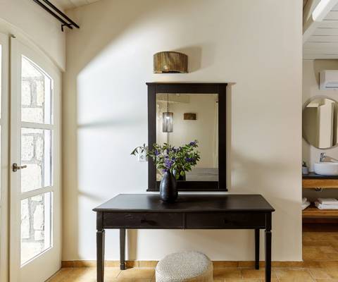 Marni Hotel House Maisonette vanity table with mirror and flower vase next to open bathroom and sea-view terrace