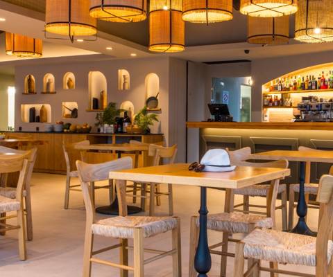 Marni Village main restaurant with warm modern lighting and wooden tables