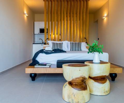 Marni Hotel Studio Private Pool modern interior with low platform bed, designer wooden stools and kitchenette