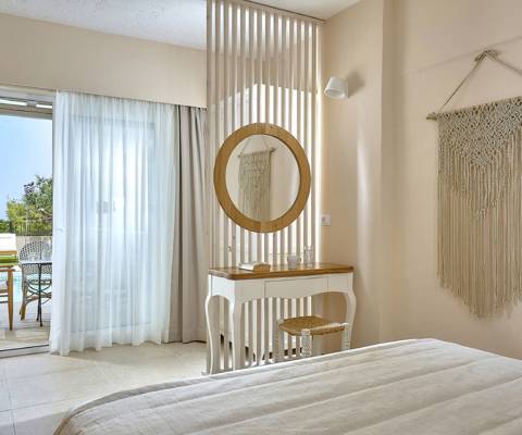 Marni Hotel Studio with Private Pool bedroom with vanity desk, macrame wall decor and access to private pool
